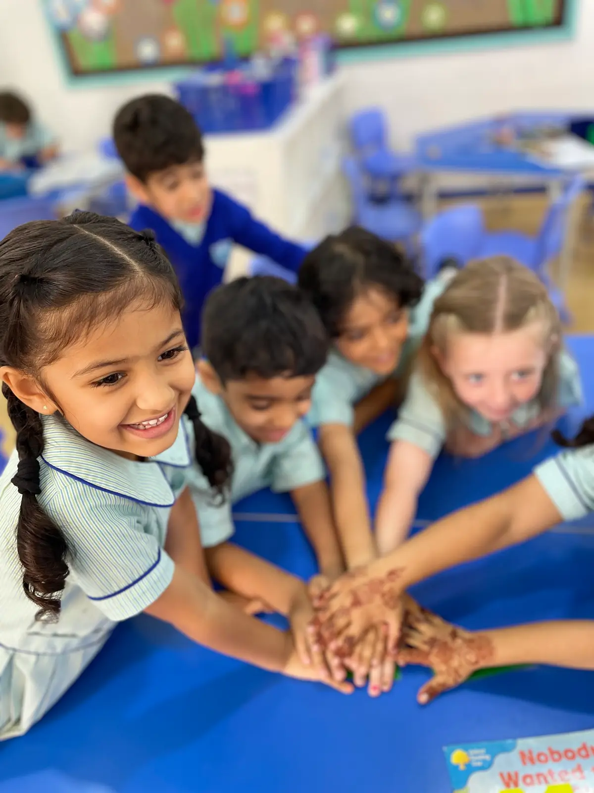 Year One children at BPS with their hands stacked together