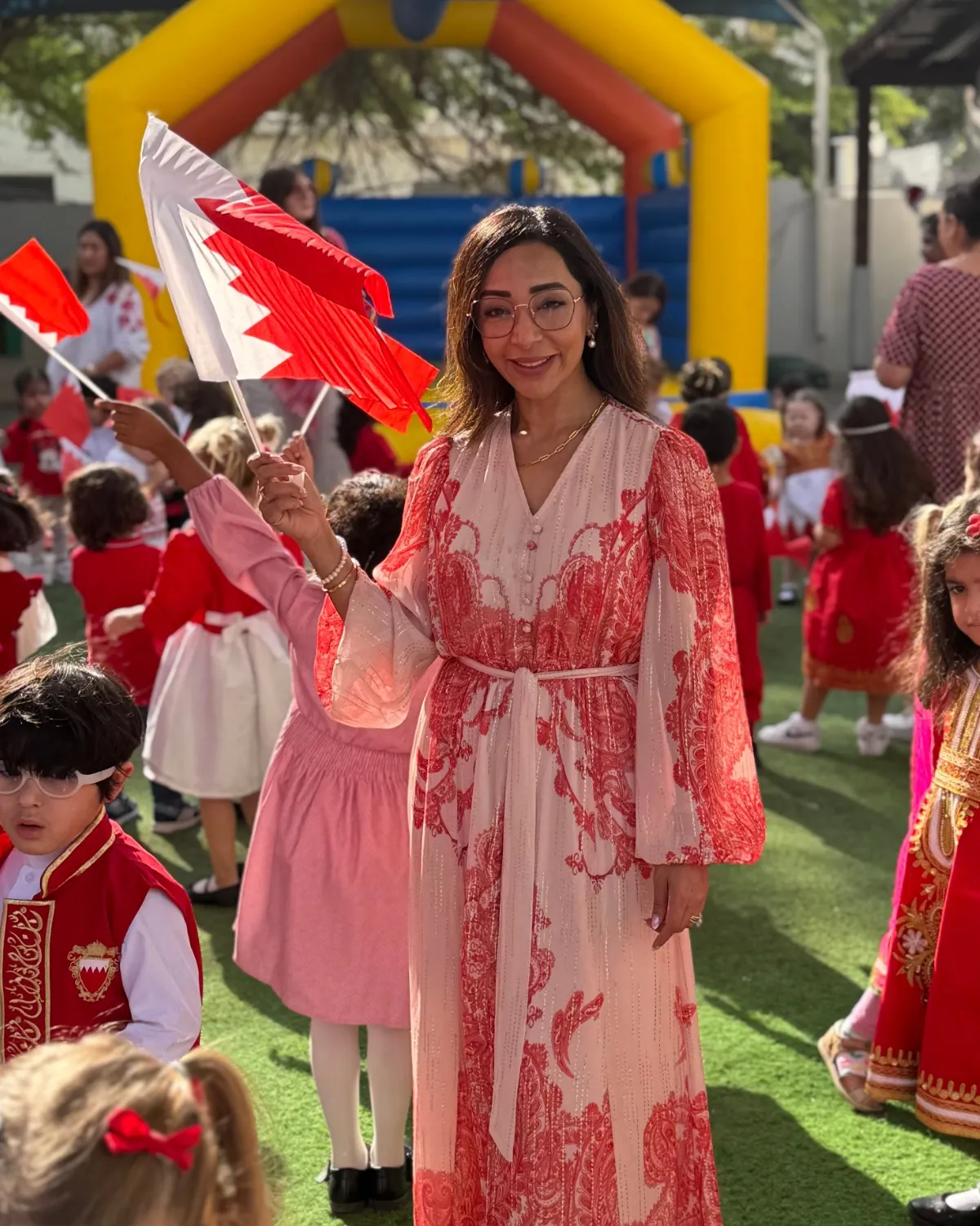 Mrs. Jasmine Smith, Principal of the British Preparatory School, with children on a national theme day