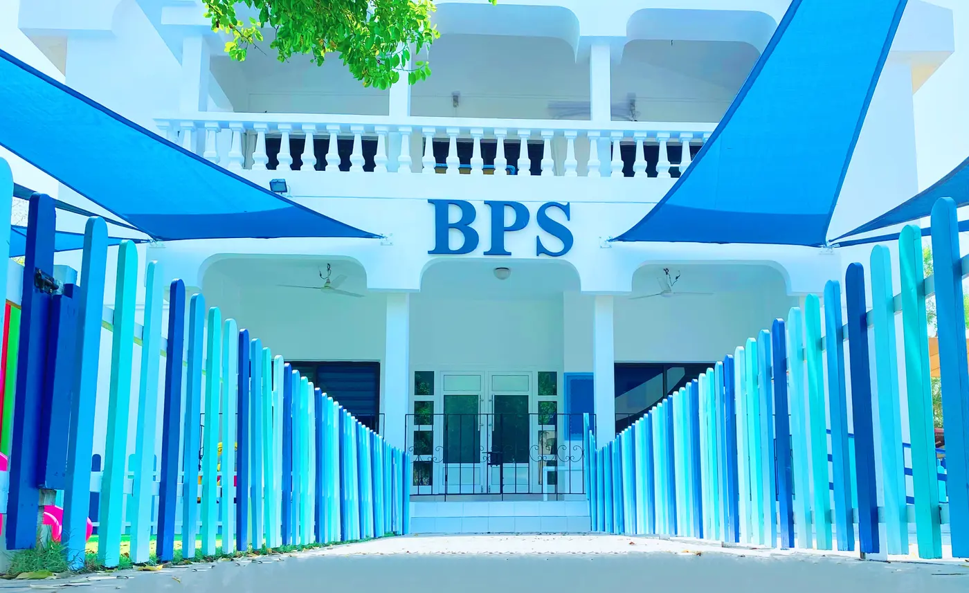 The entrance to the British Preparatory School in Saar, with its blue colonnade